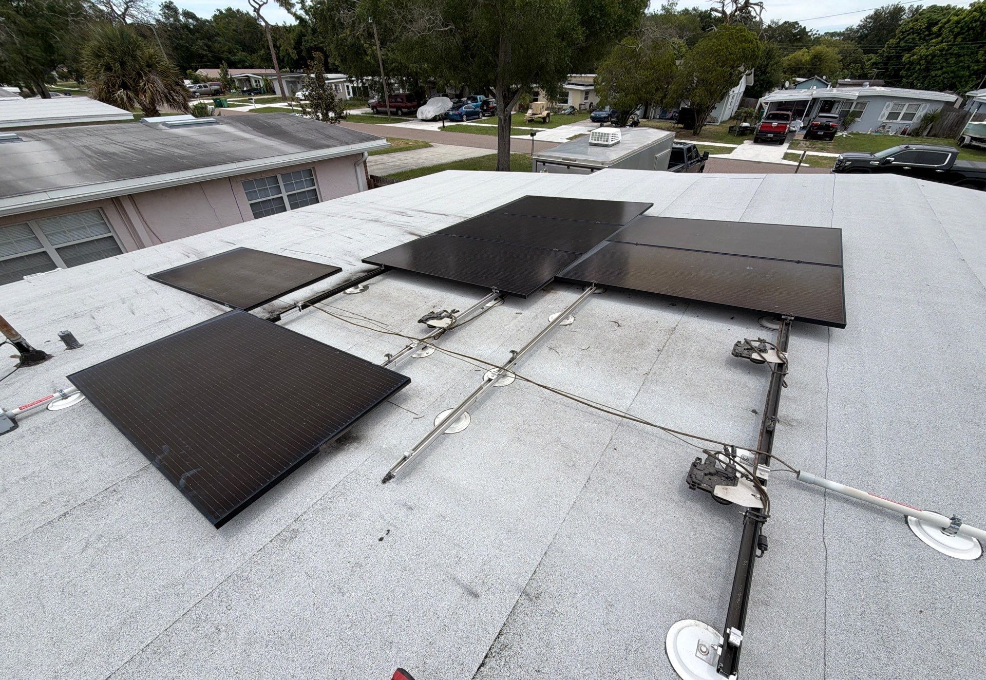 Solar panel mounting rails and standoffs on a Clearwater FL roof โ Protek Roofing & Solar