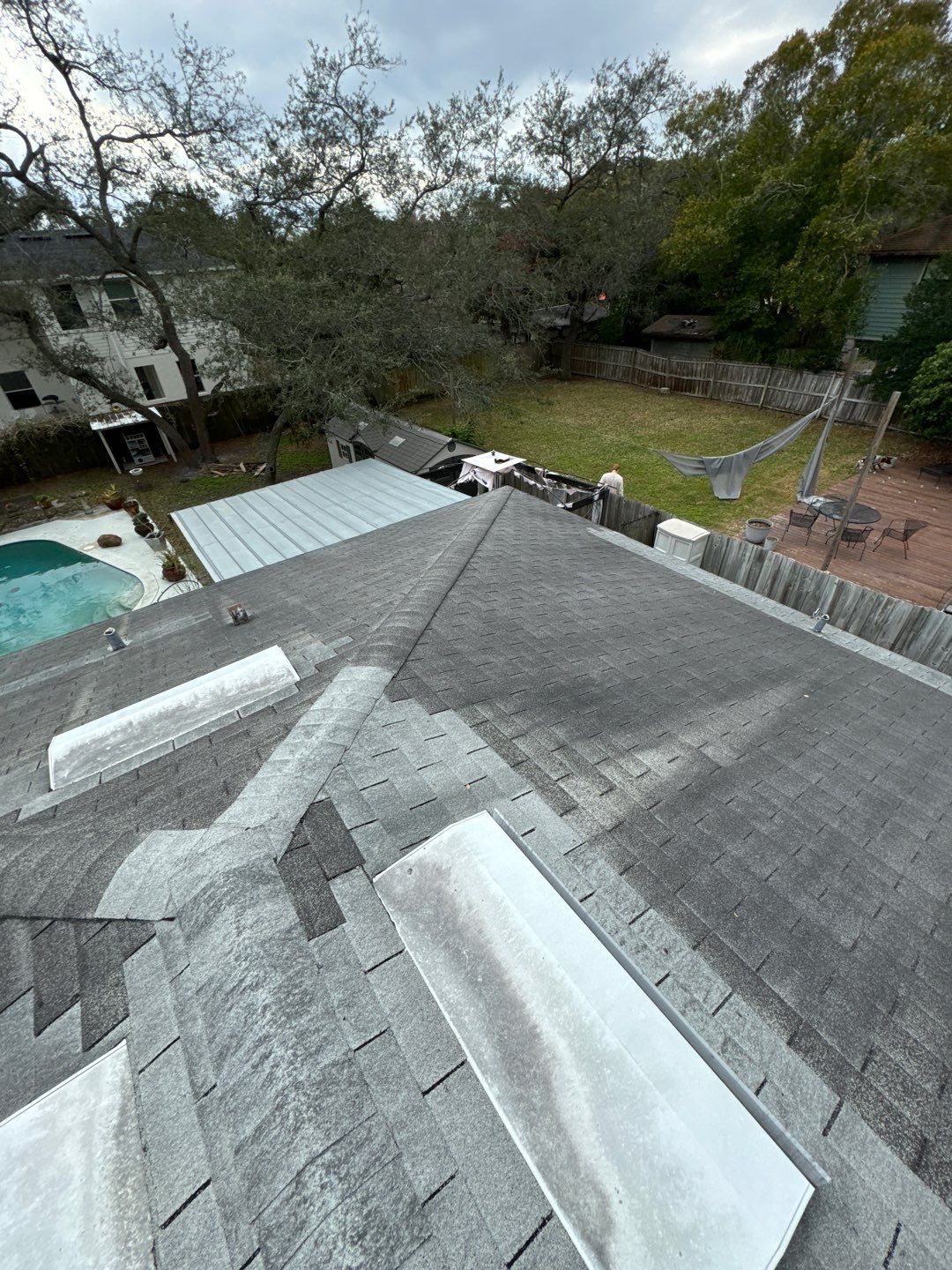 Aging gray shingle roof overview before metal replacement in South Tampa