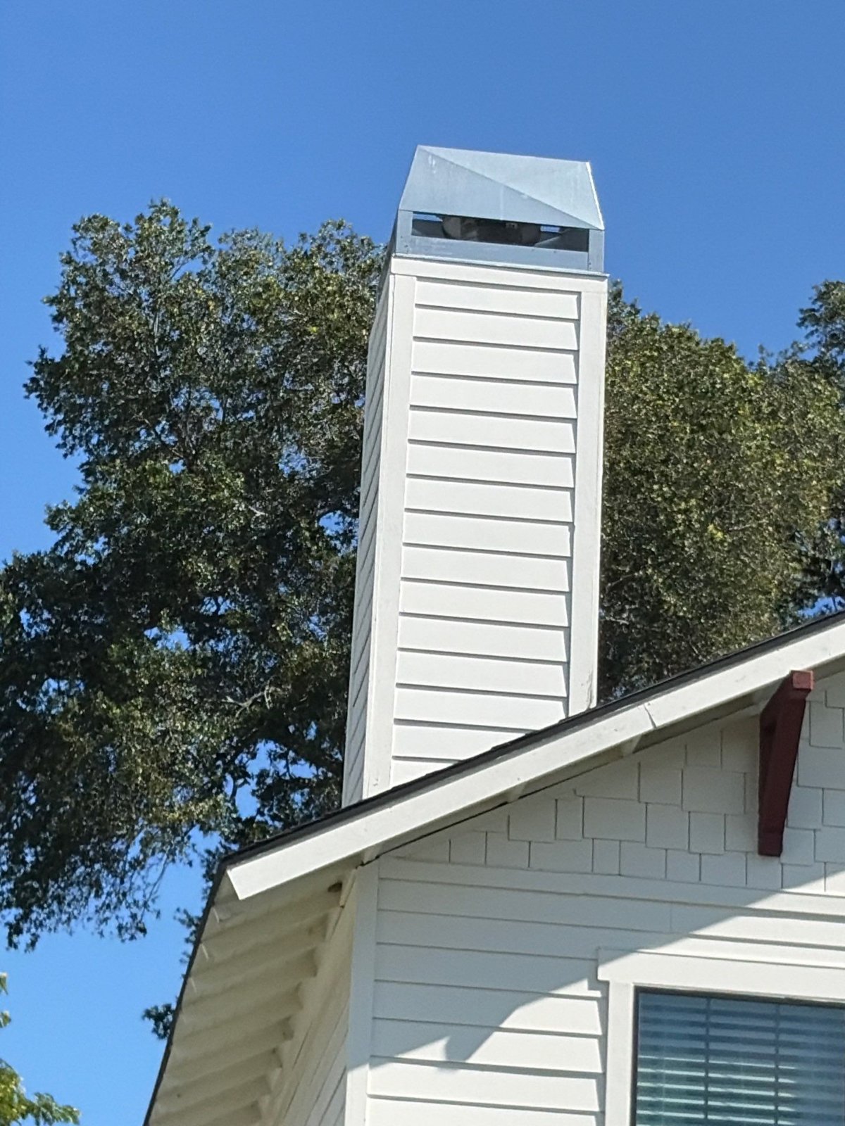 Chimney chase and cap on a Tampa FL home checked during pre-sale roof repair