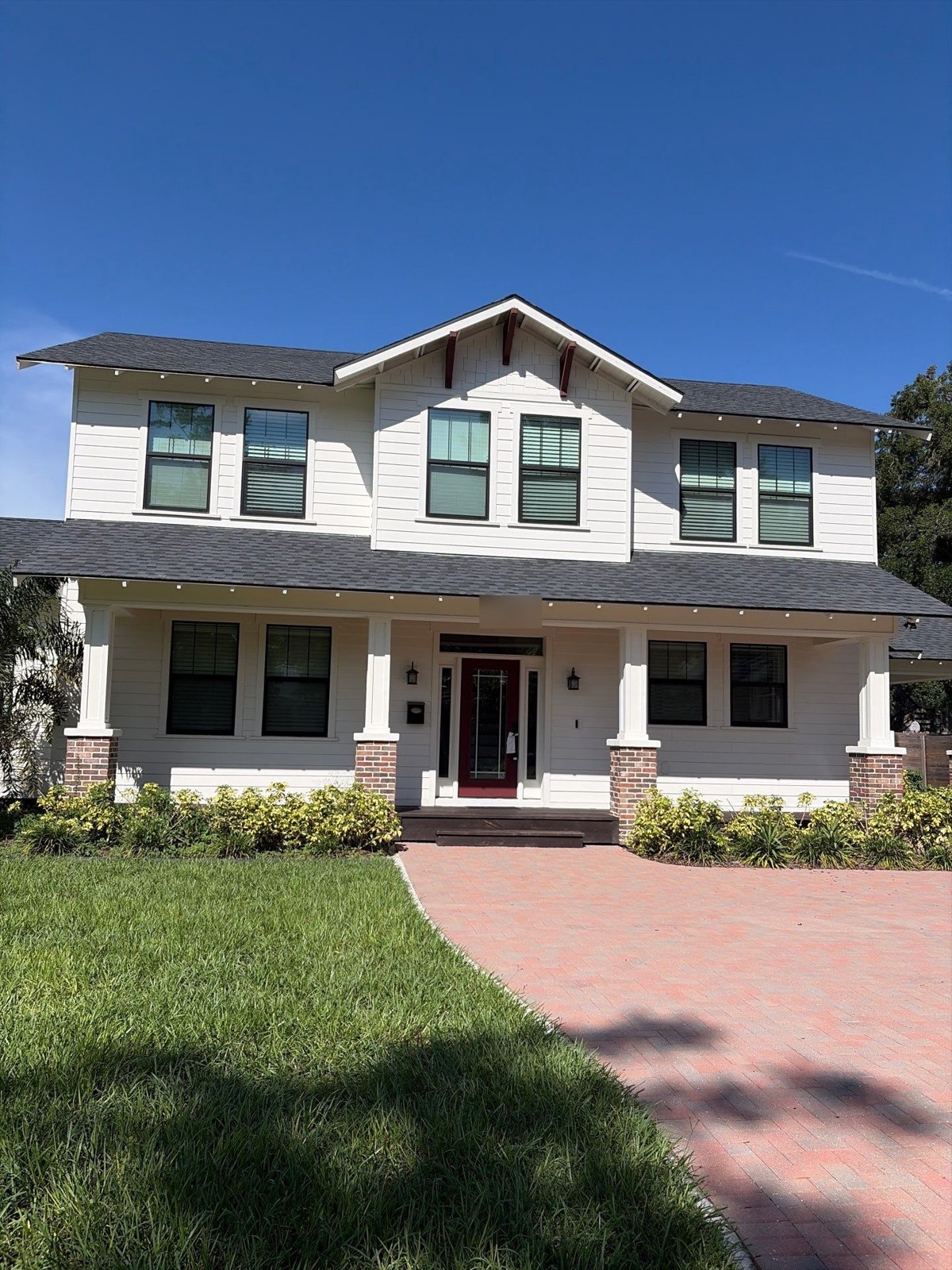 Two-story white farmhouse style home in Tampa FL after pre-sale roof repair