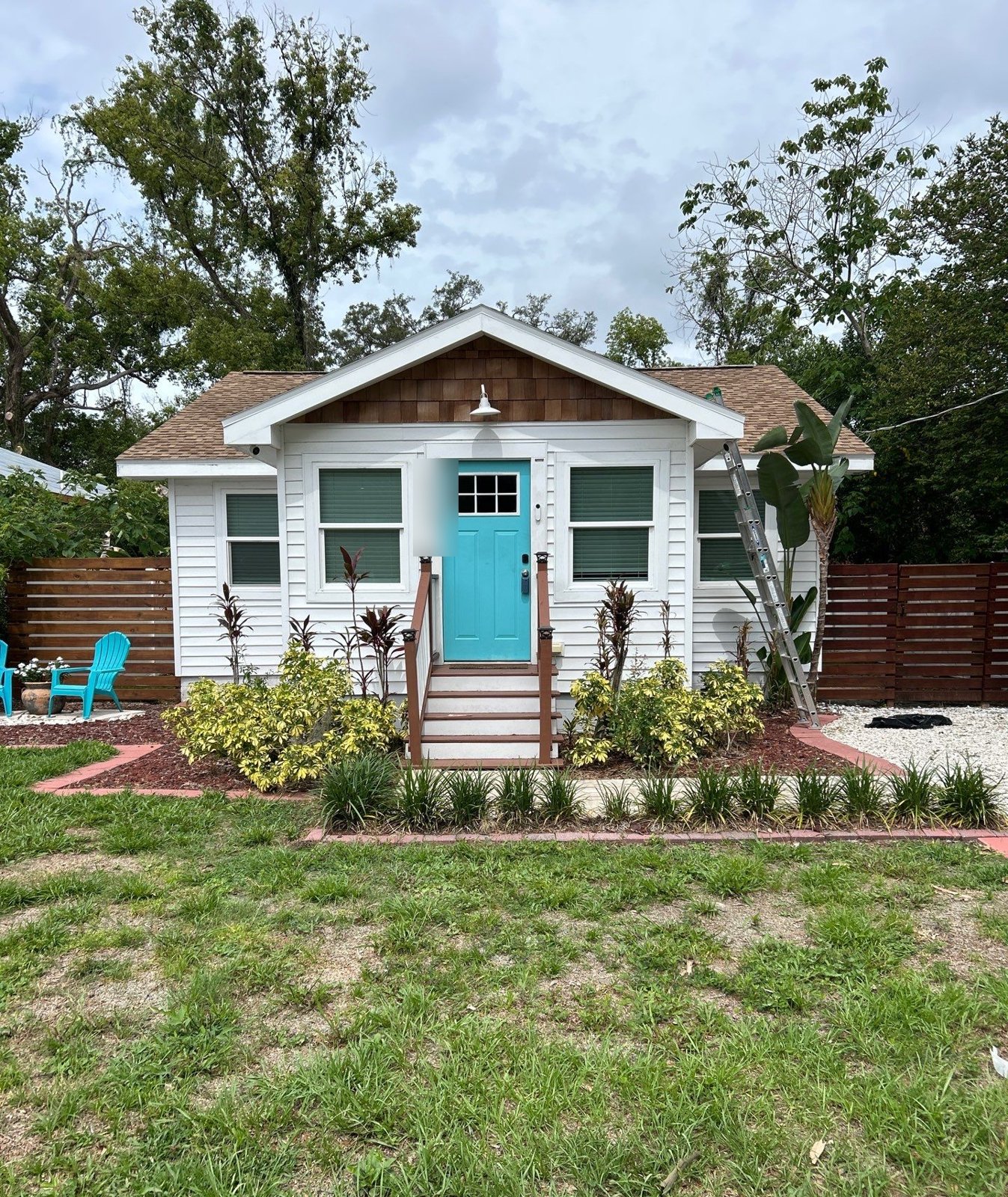 Tampa FL bungalow with repaired shingle roof after wind damage repair