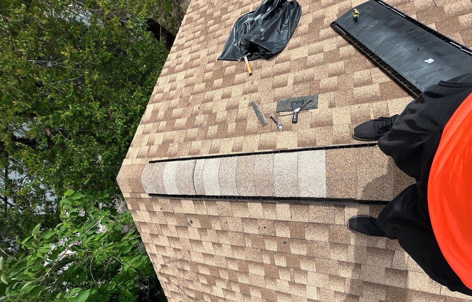 Completed ridge cap repair on a shingle roof in Tampa FL