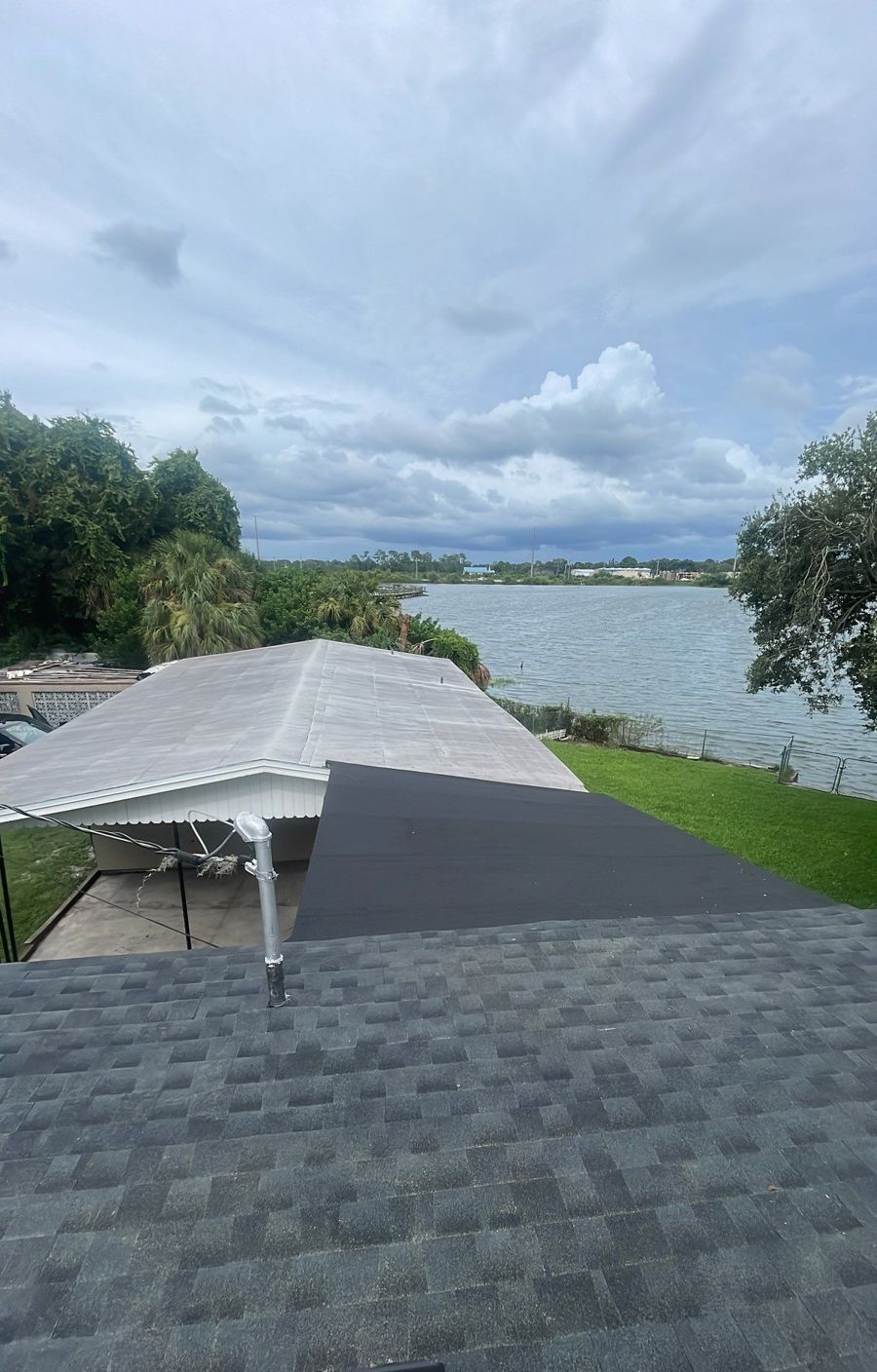 New charcoal shingle roof and low slope on a lakefront Lakeland FL home