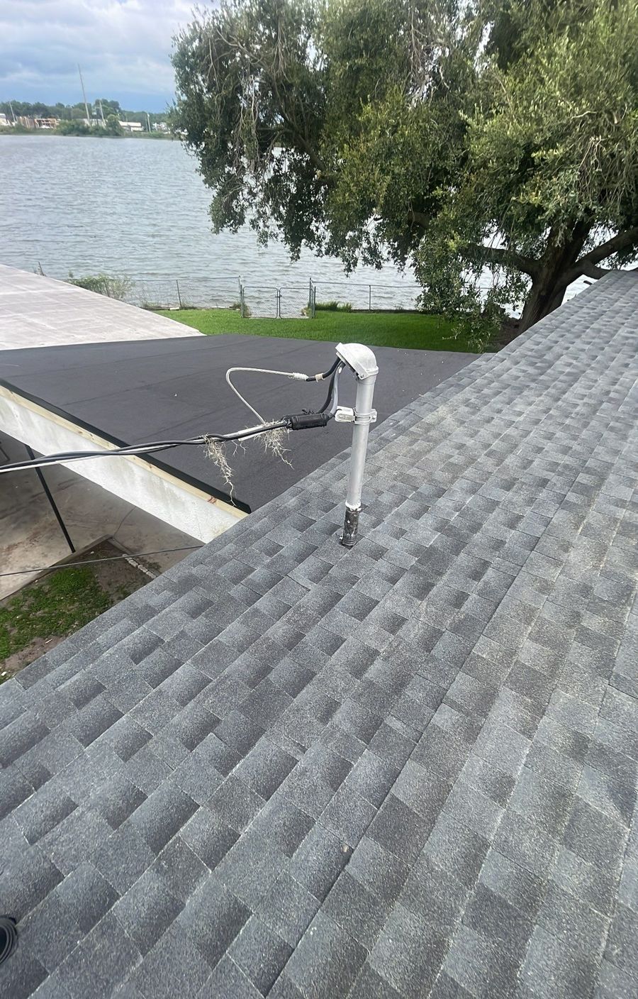 New shingle slope meeting the low slope roof on a Lakeland home