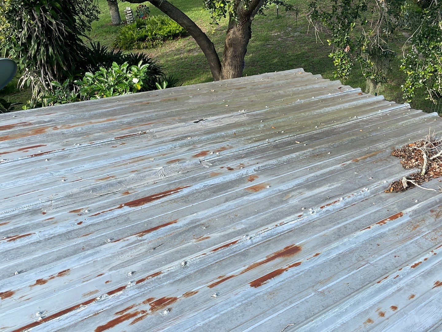 Rust spreading across old metal roof panels in Lakeland FL