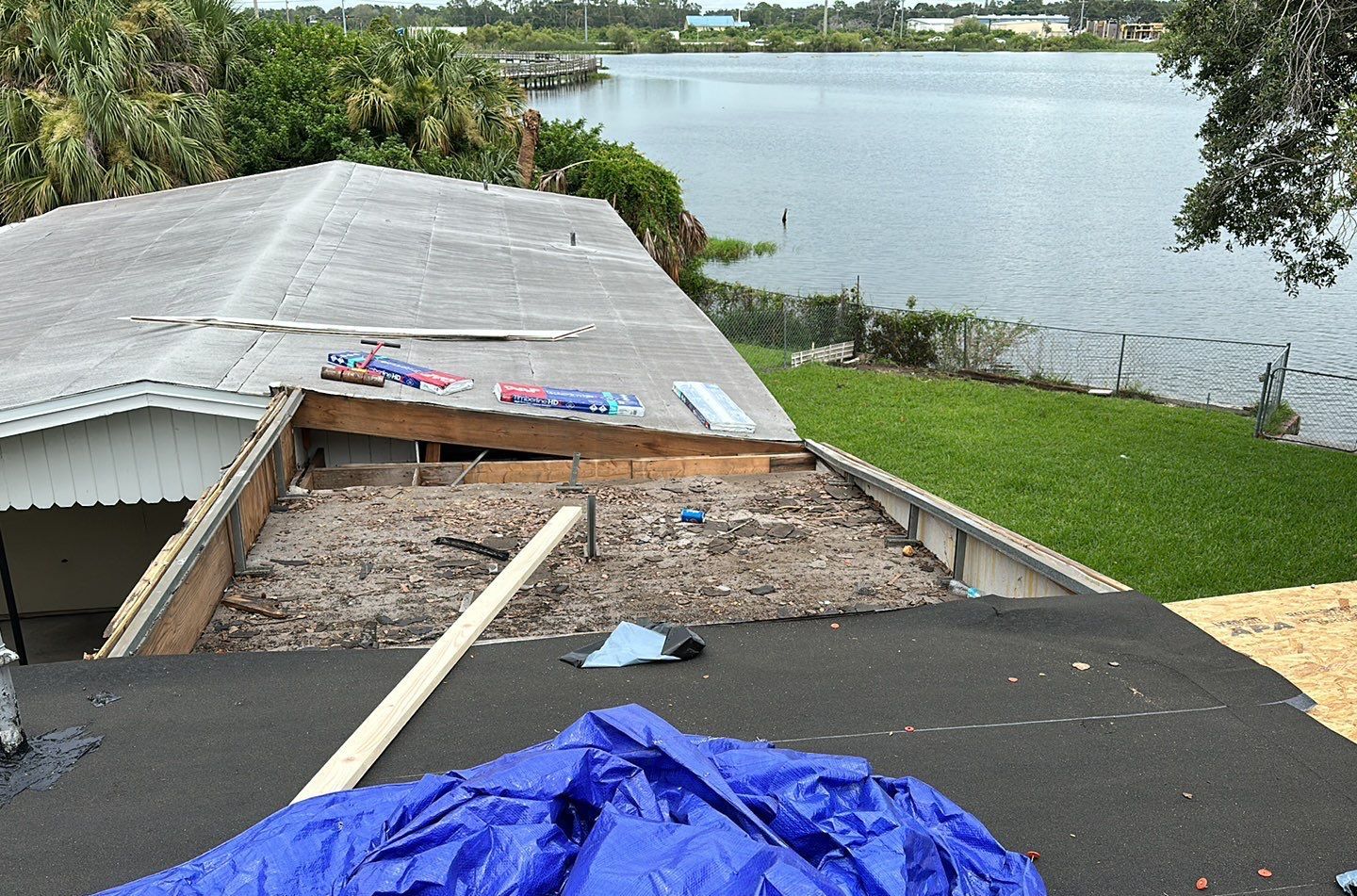 Metal roof tear-off in progress on a Lakeland lakefront home