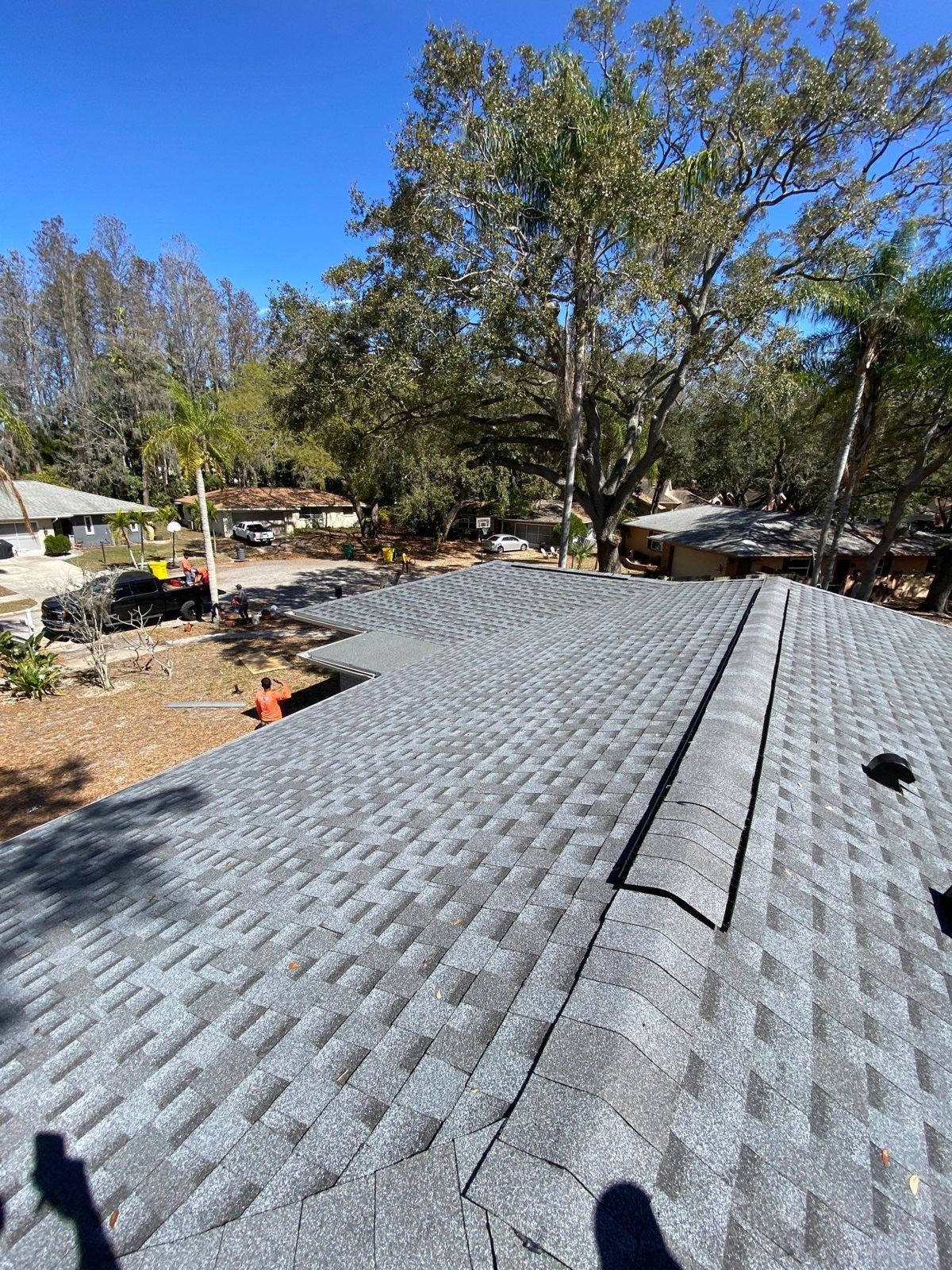 New pewter grey architectural shingle roof with ridge vent on a Palm Harbor FL home