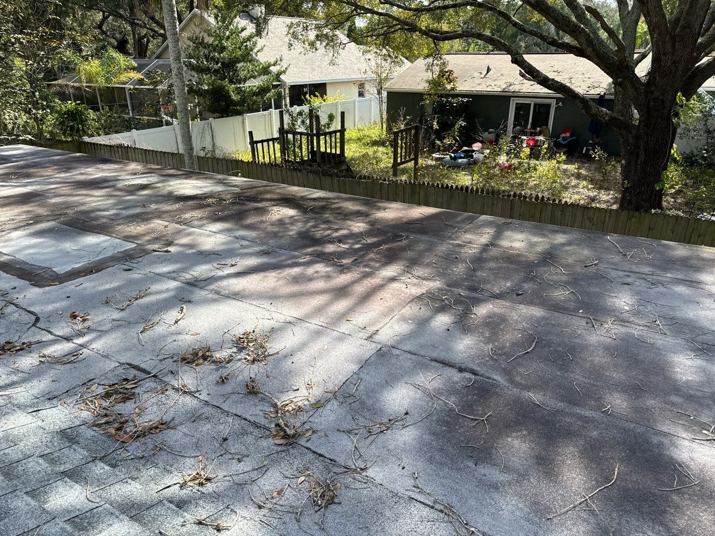 Old flat roof section covered in debris before replacement