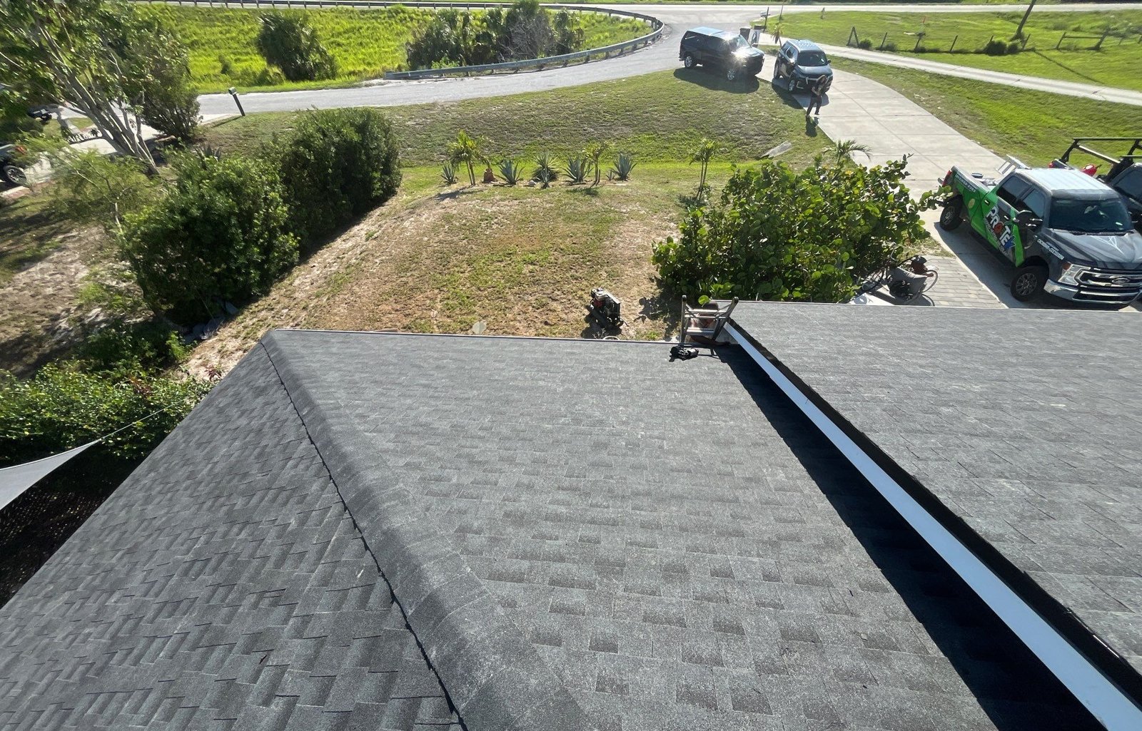 New black architectural shingles across hips and valleys of a Palmetto FL roof