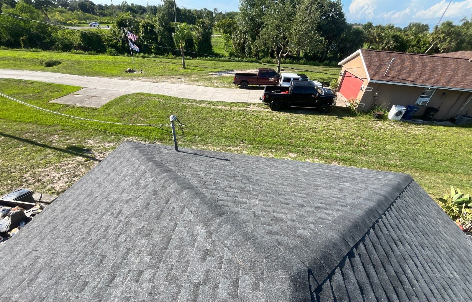 New ridge caps on a black architectural shingle roof in Palmetto FL