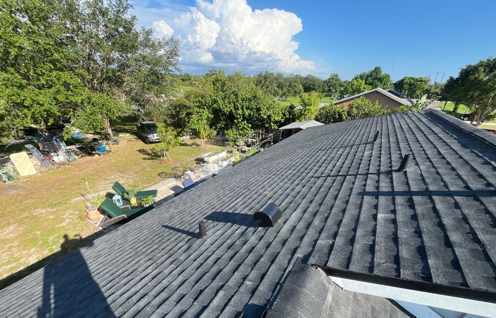 Finished black architectural shingle roof field with new vents in Palmetto FL