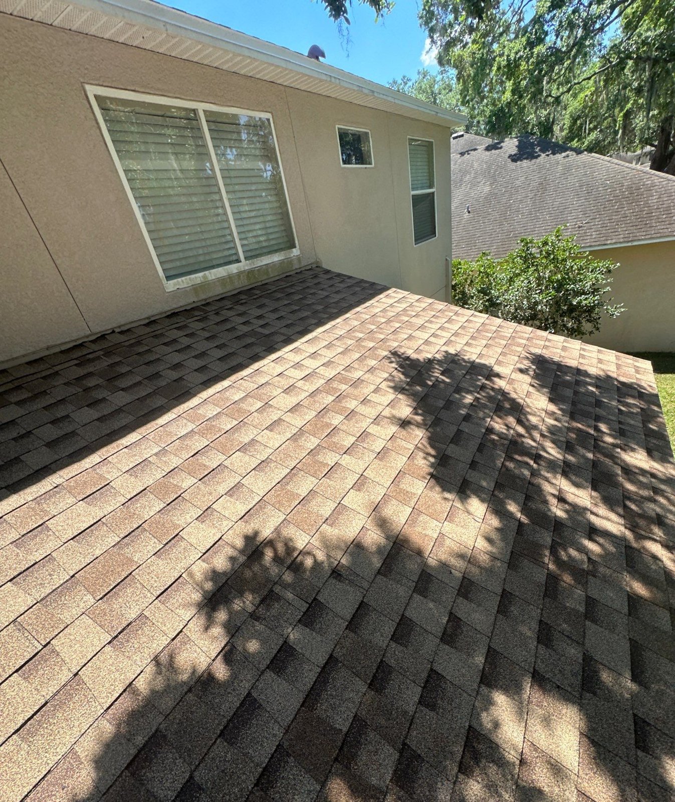 New GAF Timberline shingles on the rear roof of a two-story Riverview FL home