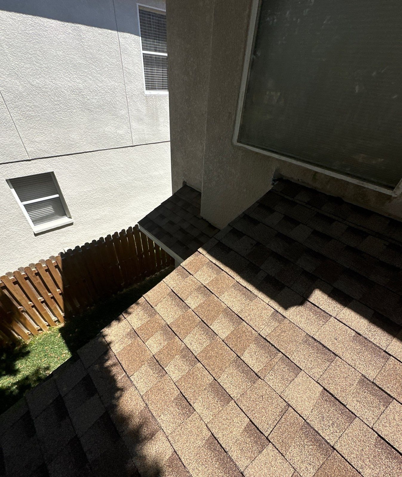 New shingle roof edge along the stucco walls of a Riverview FL home