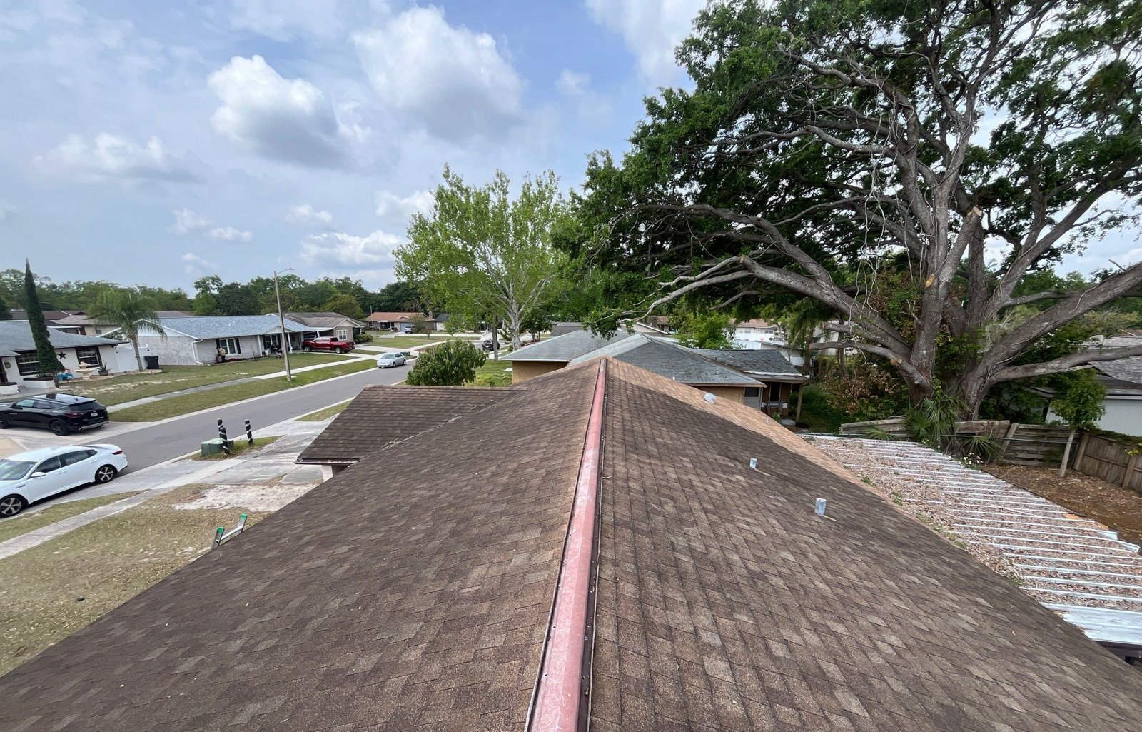 Worn brown shingle roof field from the ridge before replacement in Seffner FL