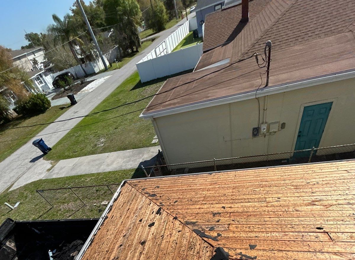 Exposed roof decking after tear-off during a shingle roof replacement in Tampa FL