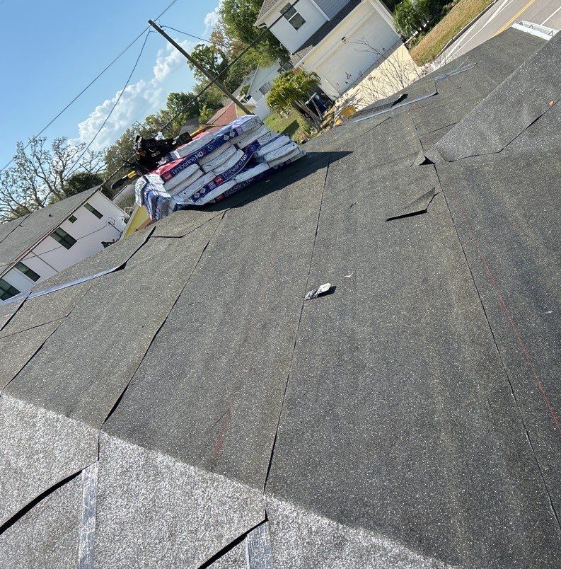 New underlayment installed across the roof deck with shingle bundles staged in Tampa FL