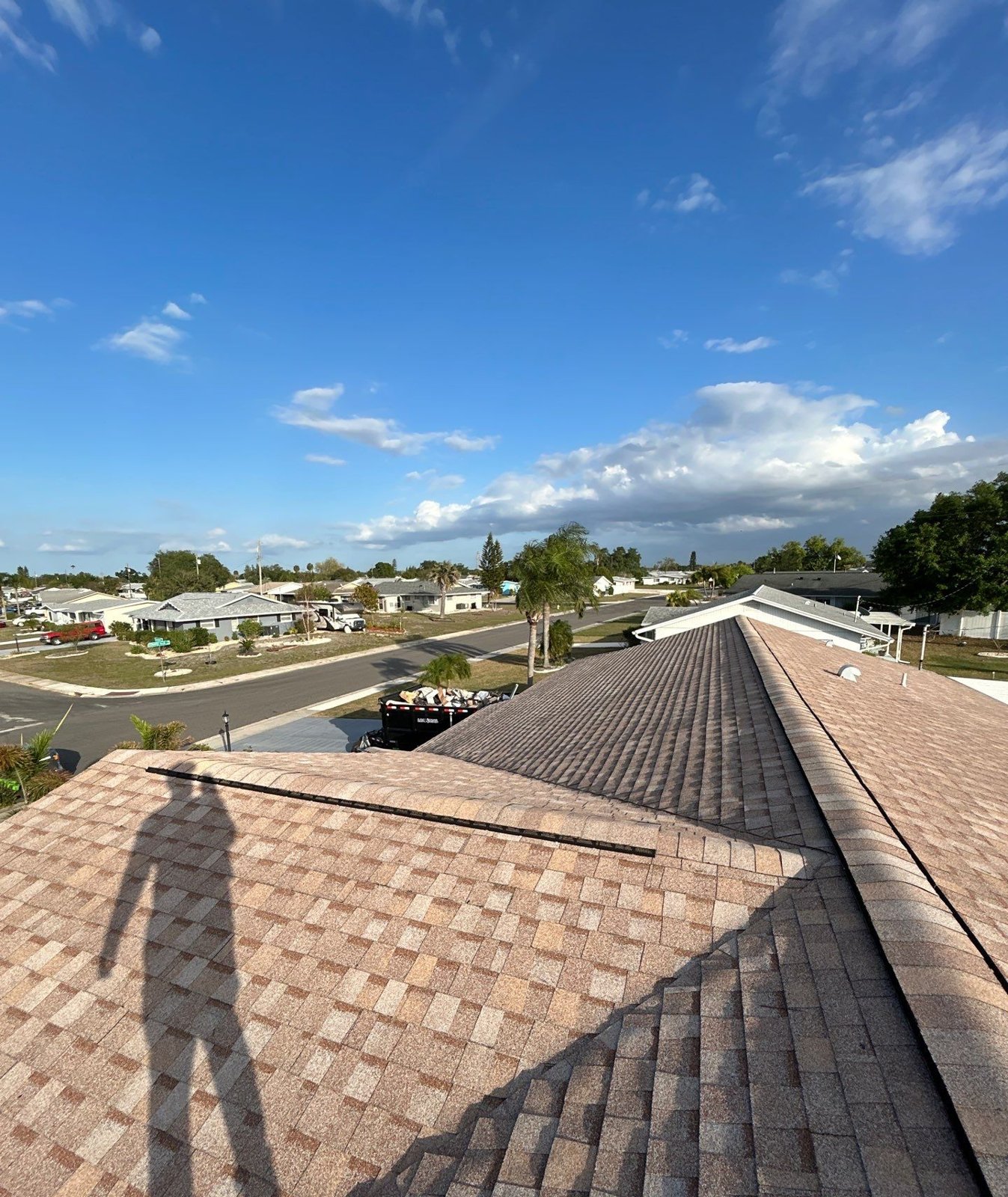 New light tan architectural shingle ridgelines after roof replacement in Sun City Center FL