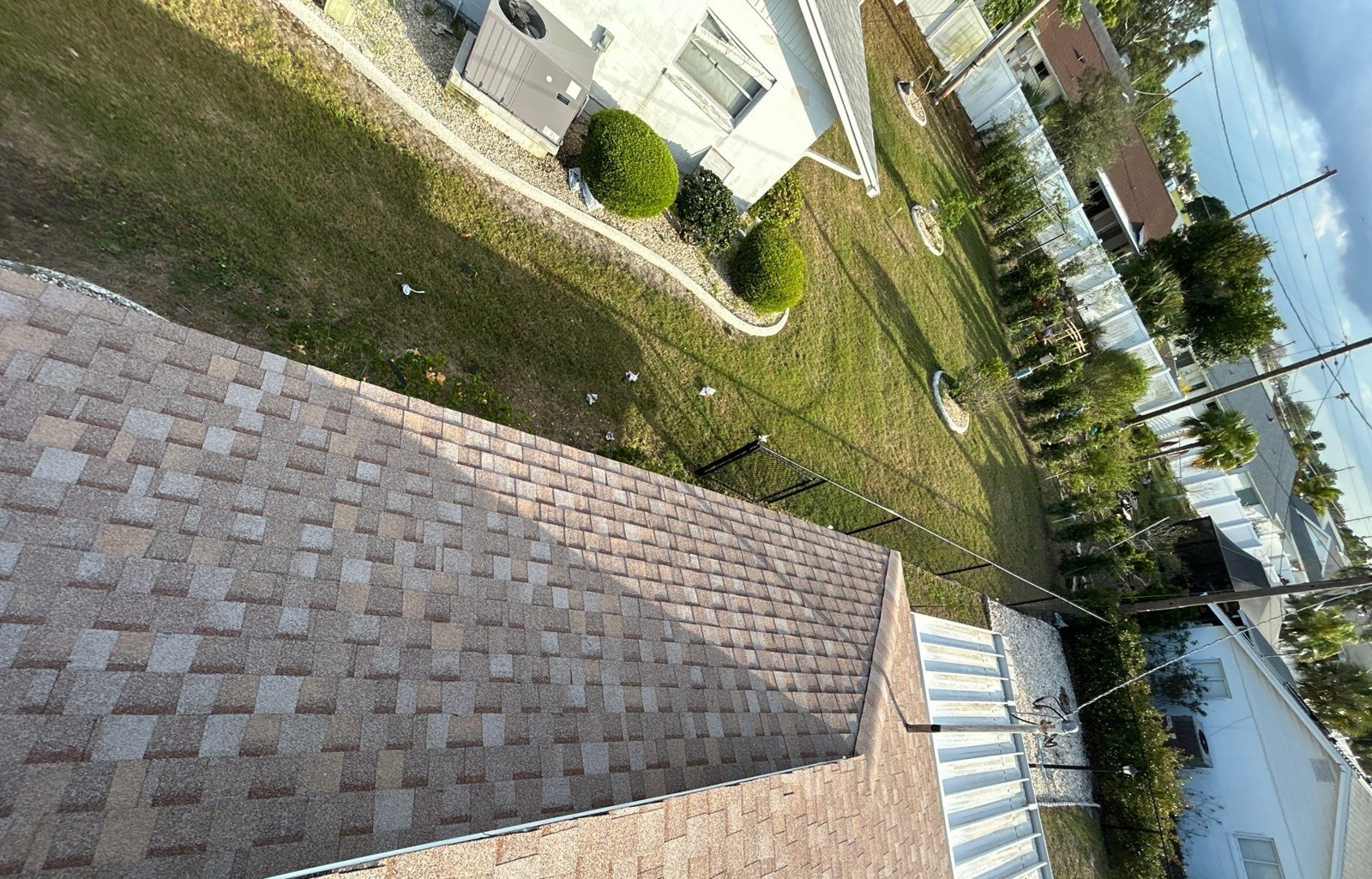 Close view of new light tan architectural shingles and ridge after replacement in Sun City Center FL