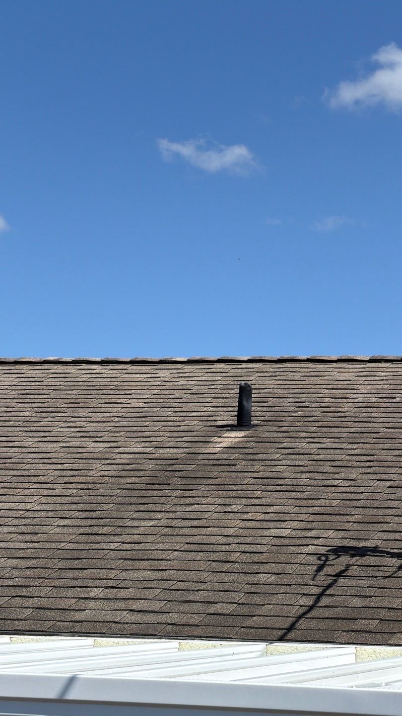 Worn brown shingle roof field with granule loss before replacement in Sun City Center FL