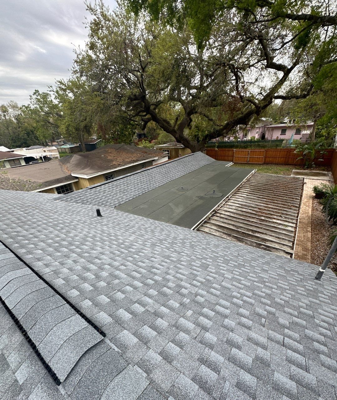 Rebuilt flat roof section tied into new shingle field in Tampa FL
