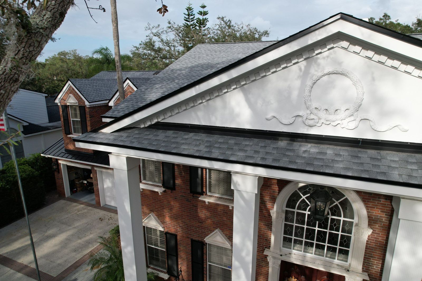 Aerial view of the front of a Tampa home after a new shingle and metal roof