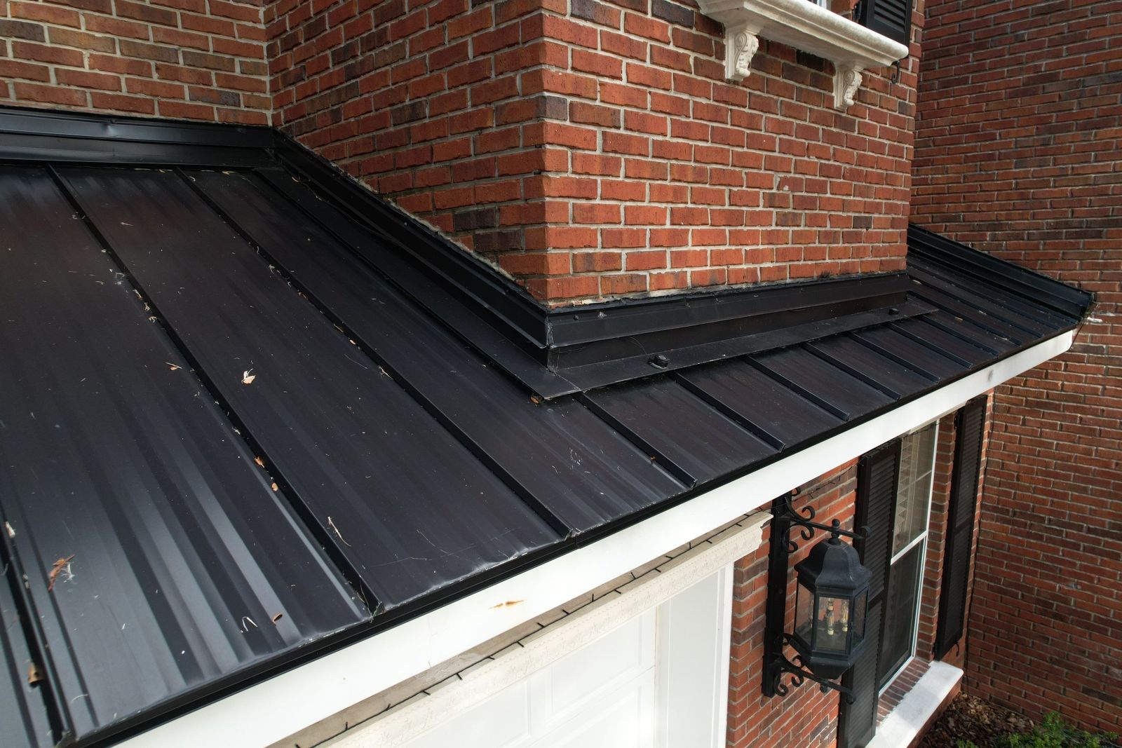 Matte black standing seam metal roof over a garage porch in Tampa FL